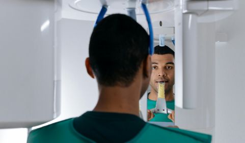 Man having mouth scanned by CBCT scanner