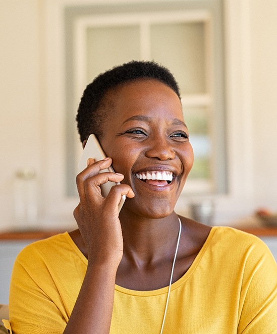 Woman smiling while talking on phone