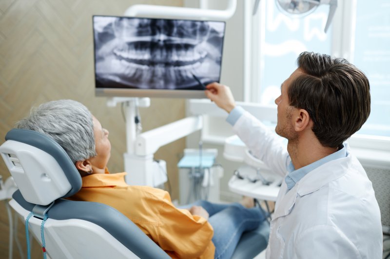 Patient talking with dentist at implant consultation