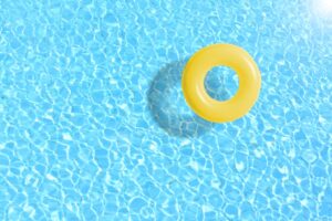 Inner tube floating in swimming pool.