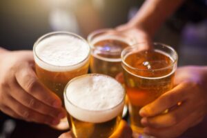 Friends cheering their glasses of beer